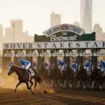 Sovereignty prances at the starting gate with a golden sun glow and a grandstand of fans beside the Belmont Stakes logo