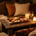 Charcuterie board arranged with vibrant meats and cheeses on reclaimed wood with French flair and candlelight