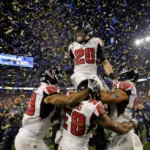 Falcons quarterback is hoisted onto teammates