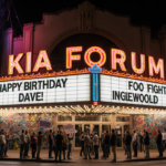 Crowd waiting at the Kia Forum marquee with colorful lights spelling FOO FIGHTERS and birthday signs