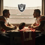 Rob Gronkowski talks to Travis Kelce at a rustic stadium table with worn footballs and faded Chiefs jerseys.