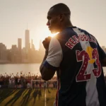 Michael Bradley standing proudly with Red Bulls jersey draped over his shoulder and New York City skyline at sunset.