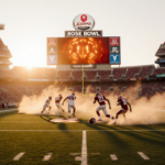 Football players kicking dust on green field with sunset Rose Bowl stadium and glowing scoreboard overhead