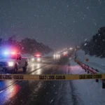 Pickup truck speeding away from camera with CHP car pursuing on snowy 110 freeway