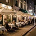 Diners enjoying winter meals at LA street tables with warm lighting and colorful winter décor