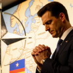 Zelenskyy stands confidently before a Europe map with a German flag in background and faint NATO stars foreground