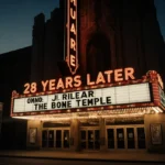 28 Years Later The Bone Temple marquee glows at dusk with bold title and release date visible on empty city street