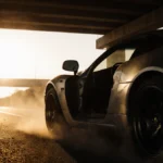 Abandoned sports car screeching to a halt under freeway overpass with golden hour light and dust clouds