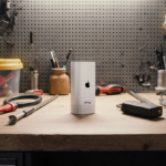 Apple AirTag 2 gleaming on workbench with tools and cables arranged neatly and warm industrial backdrop.