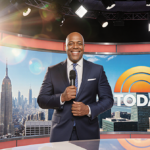 Al Roker standing proudly with microphone and TODAY logo behind him on a bright sunny morning news desk