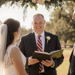 Patrick Murphy officiating wedding with Amanda Locke and groom smiling under a warm golden wooden arch