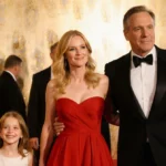 Amy Madigan walking Golden Globes red carpet with Ed Harris and Lily wearing elegant red gown and tuxedo