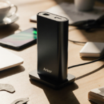 Anker MagSafe Battery sits centered on cluttered desk with laptop and phone nearby