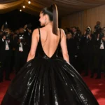 Ariana Grande walks the Golden Globes red carpet with shimmering black gown and high ponytail