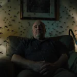 Richard Johnson sitting at home exhausted with nightlights and handheld vacuum cleaners near him.