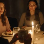 Bella Hadid cradles coffee cup at candlelit table with castmates sharing dessert and warm conversation