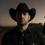 Bryce Dickey standing alone with a dimly lit desert dusk and a faint cowgirl silhouette.