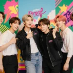 BTS all seven members standing together with dynamic pose against vibrant K-pop backdrop and warm nostalgic lighting