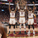 Collin Sexton Caris LeVert and Evan Mobley celebrate Cleveland Cavaliers with confetti while a LeBron James sits on the bench