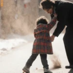 Person typing on laptop with blank screen showing refusal message about content policy