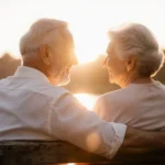 Couple holding hands while gazing into each other