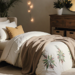 Cozy winter living room displays reversible quilt on chaise lounge with golden lighting and wooden furniture.