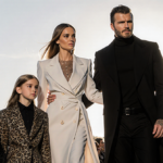 David Beckham walking proudly with his family on a Paris fashion week catwalk and Eiffel Tower silhouette in the background