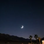 Telescope stargazing at Death Valley with crescent moon above and starry sky illuminating Dante