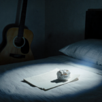 Spotlight shines on empty bed with crumpled paper and guitar silhouette in dim bedroom.