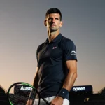 Novak Djokovic stands confidently on tennis court with Australian Open logo behind him and sunset glow on his face