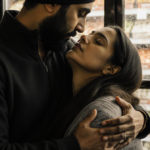 Faris carries rescued woman into Evans Food Mart with warm light and grateful embrace