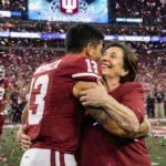 Fernando Mendoza embraces his mom Elsa with confetti swirling around them on the college football championship field.
