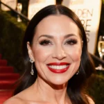 Fran Drescher walking the red carpet with glowing skin and bold red lips at the Golden Globes