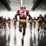 Fred Warner sprinting through stadium tunnel with jersey 54 visible and teammates behind