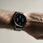 Wrist displays Garmin Venu 4 sports smartwatch with metallic band and subtle button designs illuminated by natural light