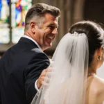 Gordon Ramsay smiling with pride while touching his daughter Holly