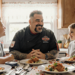 Guy Fieri smiling while his sons Hunter and Ryder chat in a cozy kitchen with cookbooks and bright natural light
