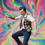 Harry Styles dancing energetically with vibrant swirling patterns and psychedelic colors creating a feverish atmosphere