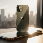 Futuristic iPhone 18 prototype glows with golden sunlight on a wooden desk with blurred cityscape behind