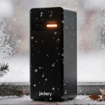 Jackery HomePower 3000 glows with warm LED light and snowflakes fall outside a frosty window