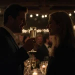 Jason Segel toasting Kayla Radomski at engagement party with champagne glasses and romantic candlelight