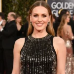 Jennifer Garner poses on the red carpet with beaded black dress and golden lighting