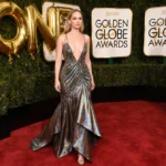 Jennifer Lawrence walks the red carpet with avant-garde metallic gown and gold balloons