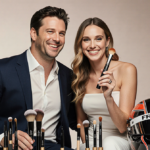 Jillian Dempsey smiling and holding up a makeup creation with makeup brushes and an acting award nearby