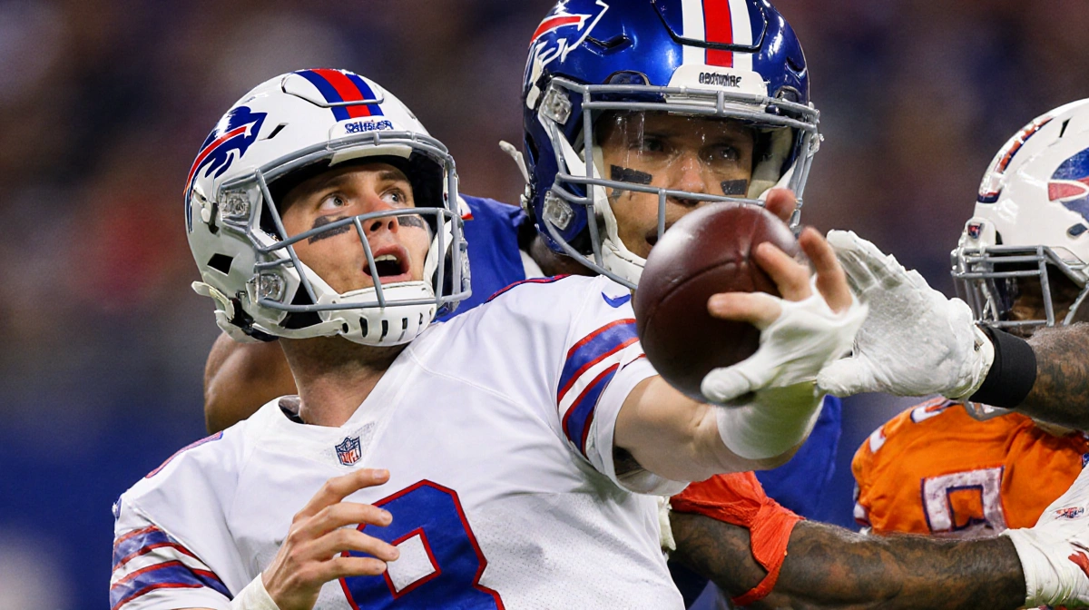 Josh Allen throwing interception with defender catching ball and shocked expression on his face