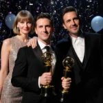 Josh Charles holds his Moon Person trophy with Ethan Hawke and Taylor Swift standing behind them at the 2024 MTV VMAs backsta