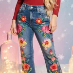 Kelly Clarkson poses in embroidered floral jeans with twinkling fairy lights and frosted bottles in snowy backdrop