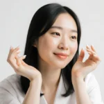 Kitty Wan sits with relaxed hands and manicured nails with subtle smile and soft natural lighting