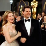 Kristin Davis laughing with Tom Cruise on the red carpet with Golden Globes backdrop and champagne flutes nearby