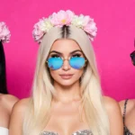 Kylie Jenner Lea Michele and Jenna Dewan pose with flower crowns and mirrored sunglasses against bright pink backdrop showing